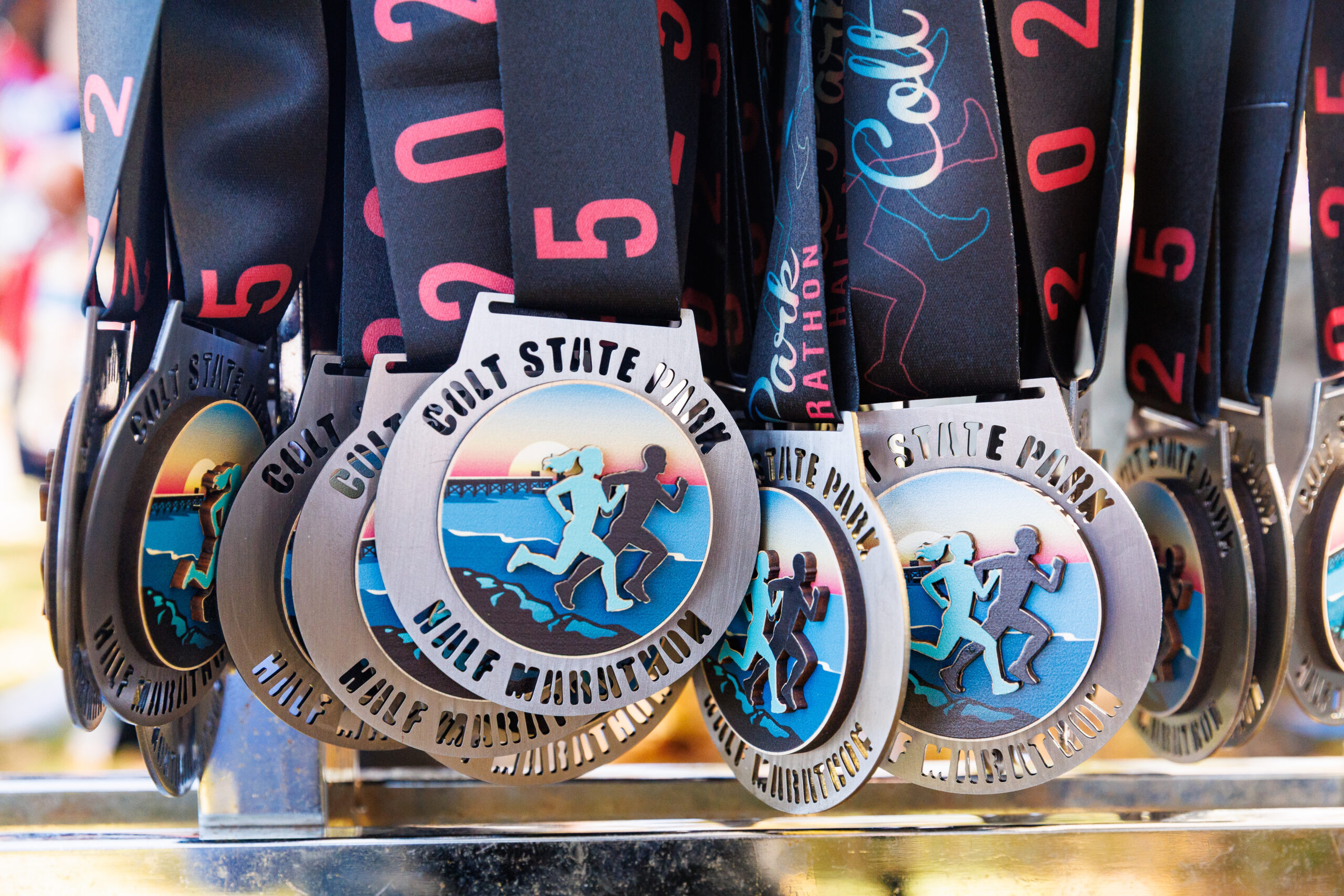 Finsher Medals hanging at the finish line of the Colt State Park Half Marathon.